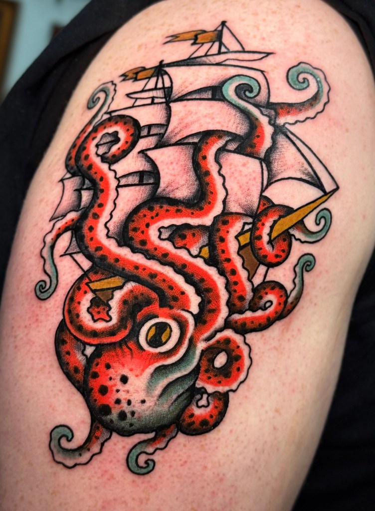 Old school octopus and sailing ship tattoo on the shoulder